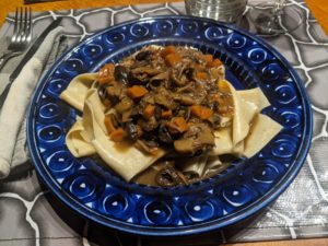 Pappardelle under a sauce of mushrooms and turkey.