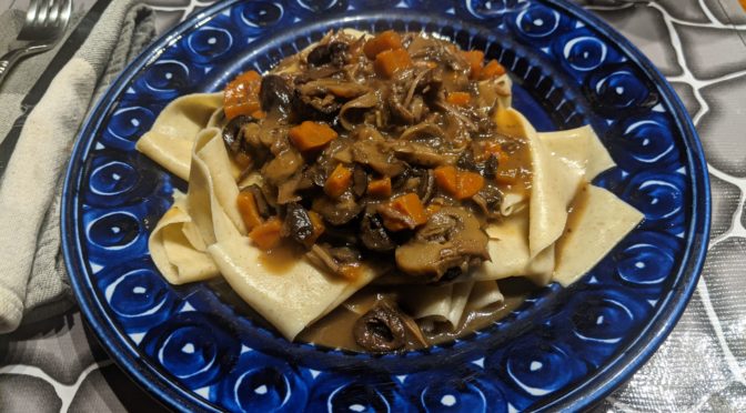 Pappardelle under a sauce of mushrooms and turkey.