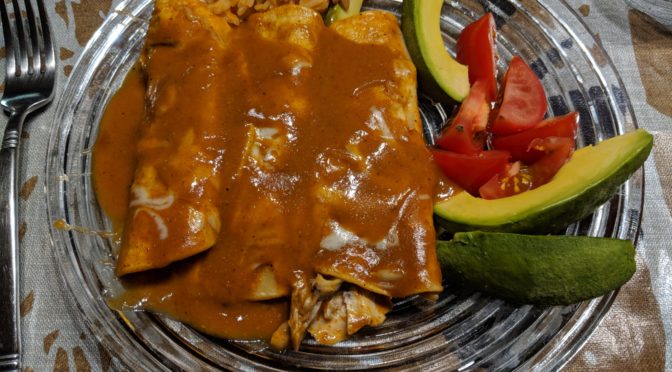 Chicken enchiladas with a little garnish on the side