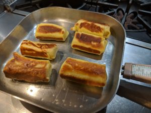 Blintzes cooking in pan